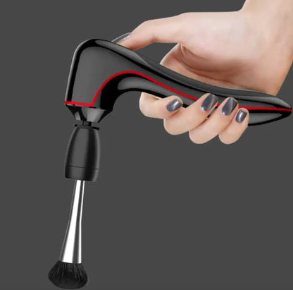 Hand holding a black and red makeup brush cleaner against a dark background