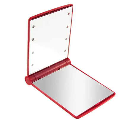 Red compact mirror with white interior on a white background
