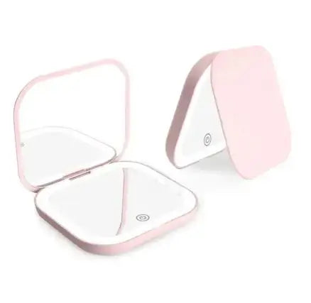 Pink compact mirror with open lid on a white background