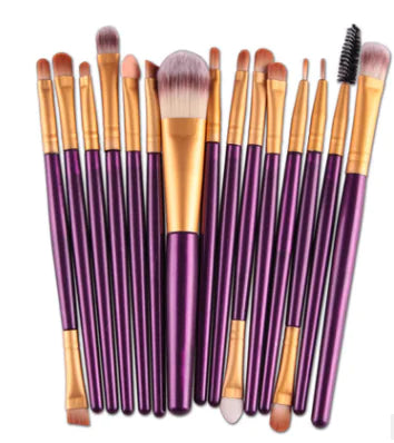 Set of makeup brushes with purple handles and gold accents on a white background