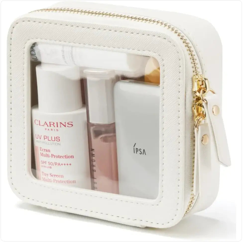 White cosmetic bag with skincare products including Clarins and Ipsa on a white background