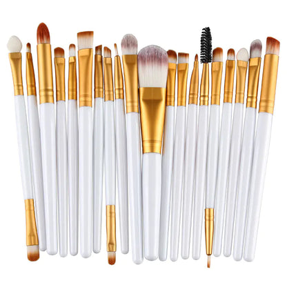 Set of makeup brushes with gold and white handles on a white background