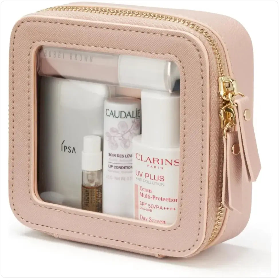 Pink travel case with skincare products including Clarins and ipsa on a white background